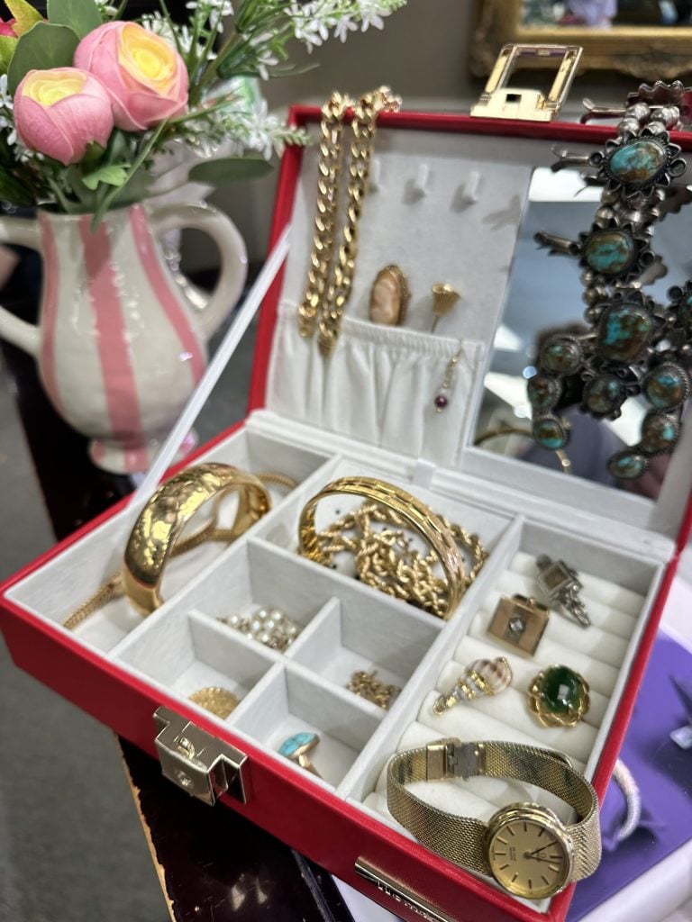 Watches, bracelets, and necklaces arranged in a jewelry display.