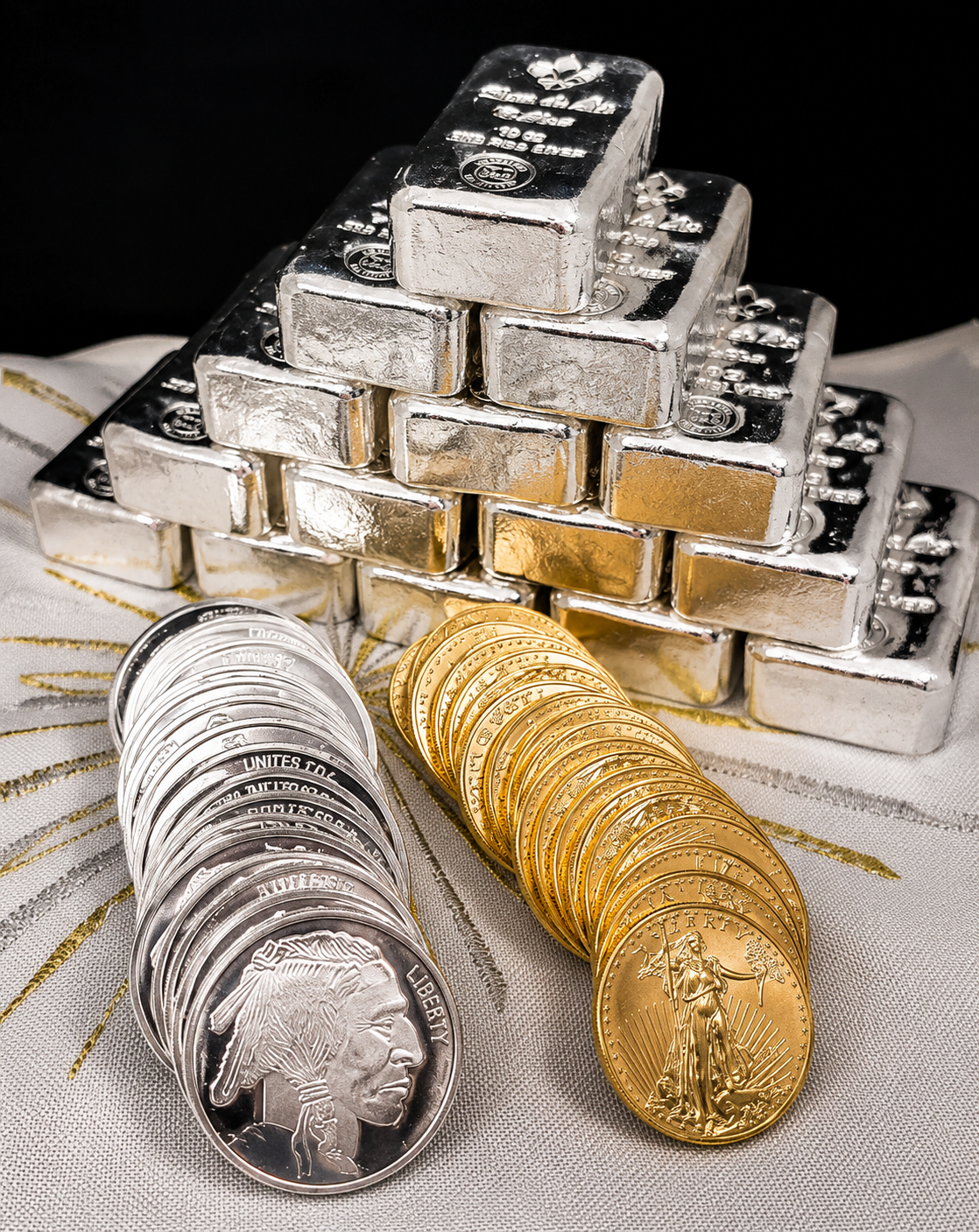 Gold and silver bullion bars stacked against a dark background.